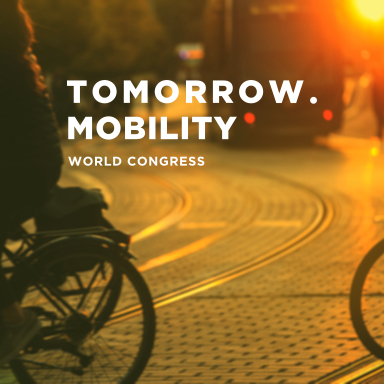 A bike riding over tramlines with the Tomorrow.Mobility World Congress logo in the foreground